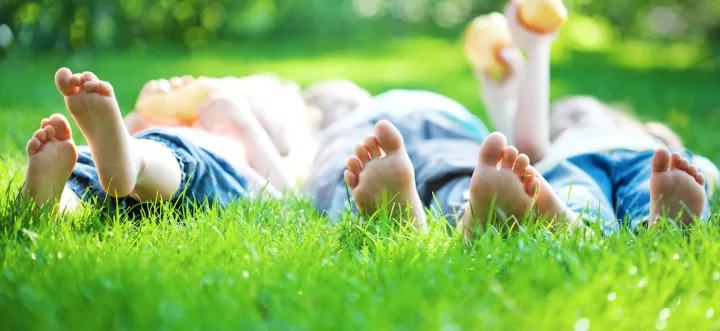 two kids laying in the lawn