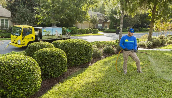 lawn tech spraying yard for pests