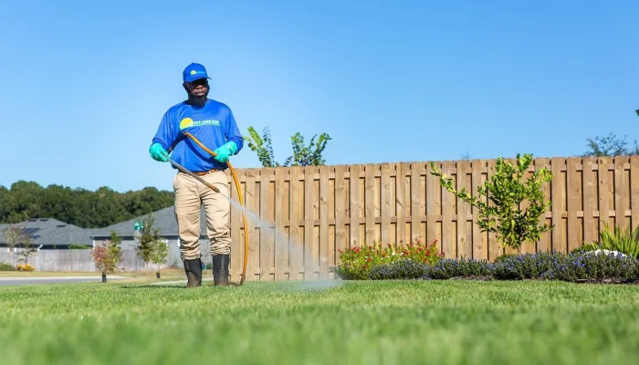 lawn tech spraying yard for pests