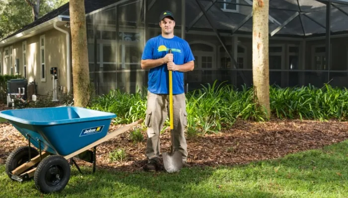 landscaping team member preparing yard for plant installation