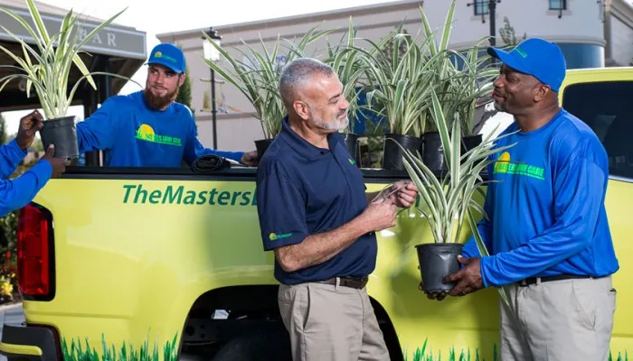 the masters lawn care technicians preparing to work on project