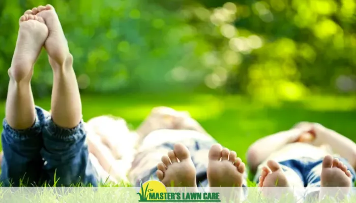 kids laying in a green lawn