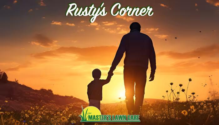 father and son holding hands walking into the sunset