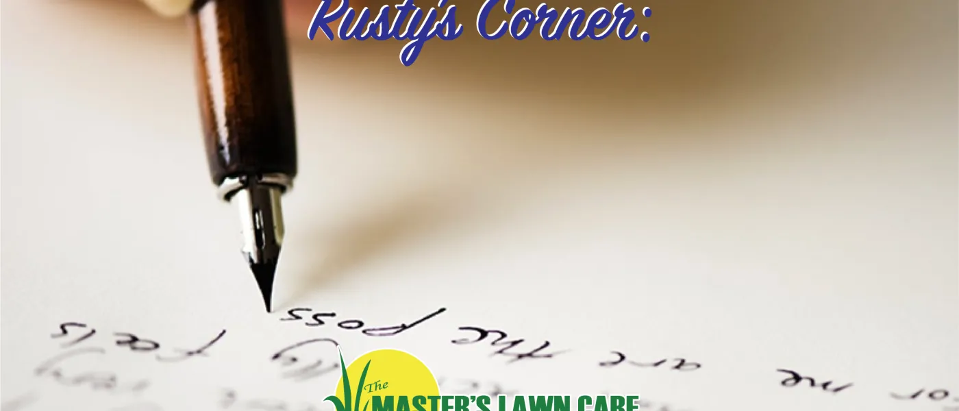 close up image of a pen writing a letter on paper