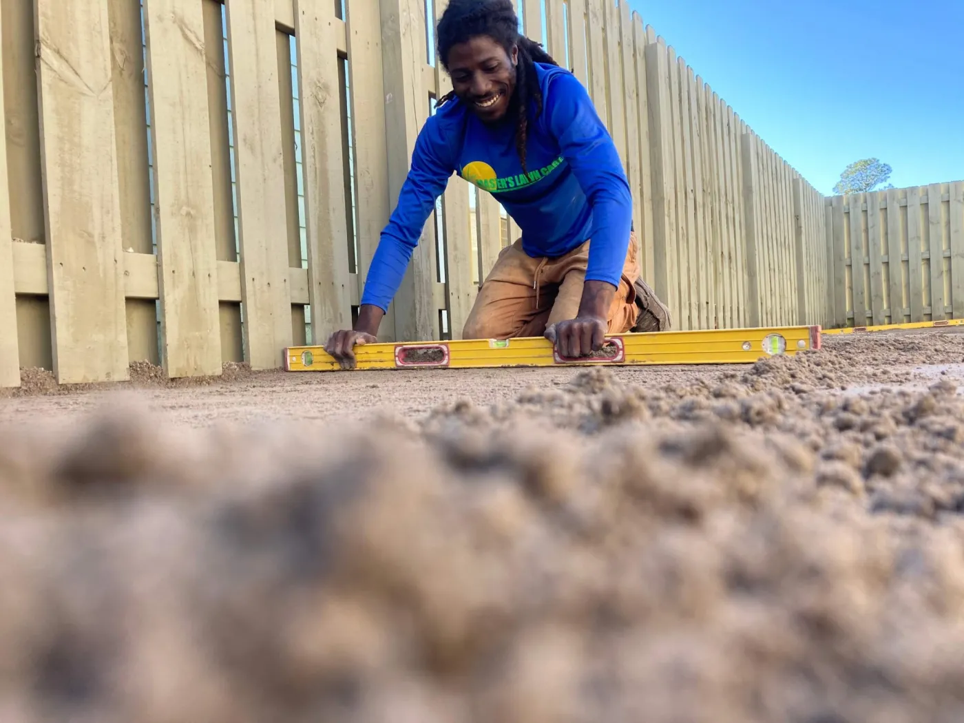 team member leveling out dirt