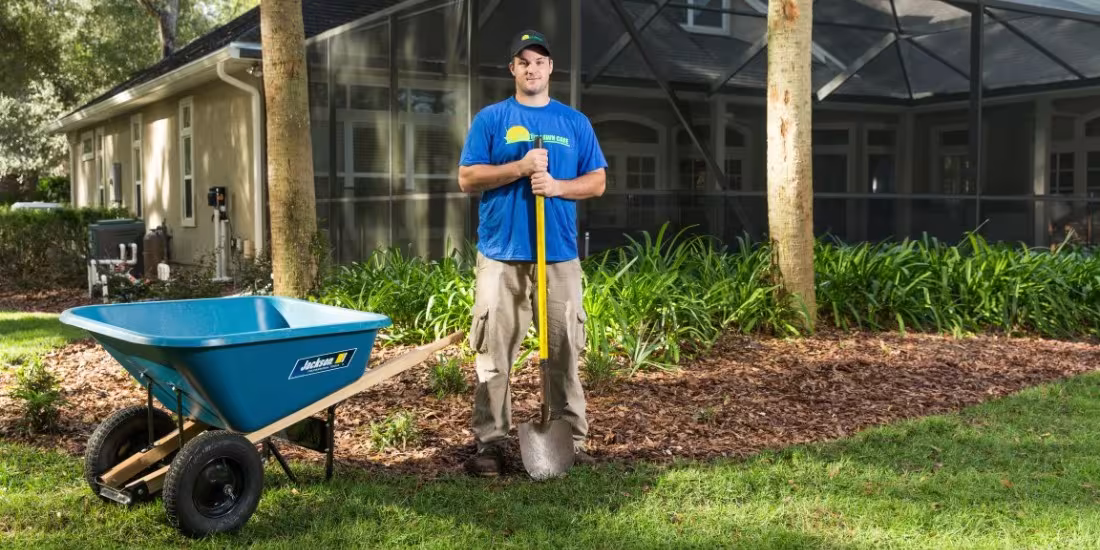landscaping team member preparing yard for plant installation