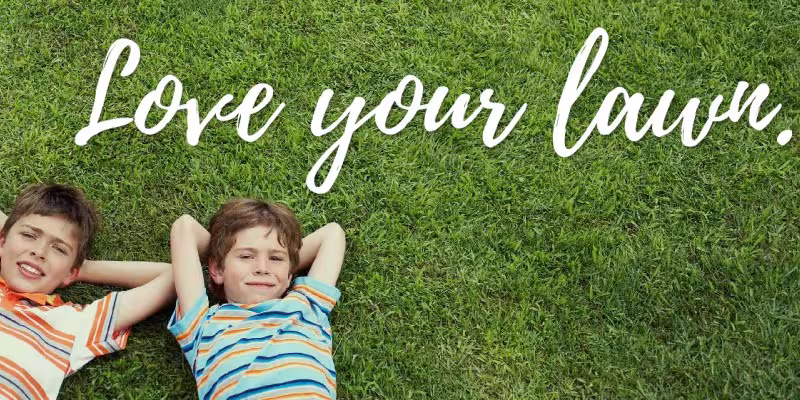 two kids laying in the lawn