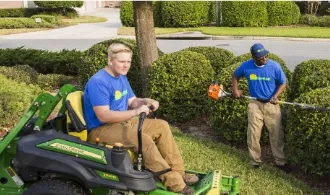 lawn maintenance technicians working in yard