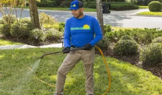 team member spraying lawn