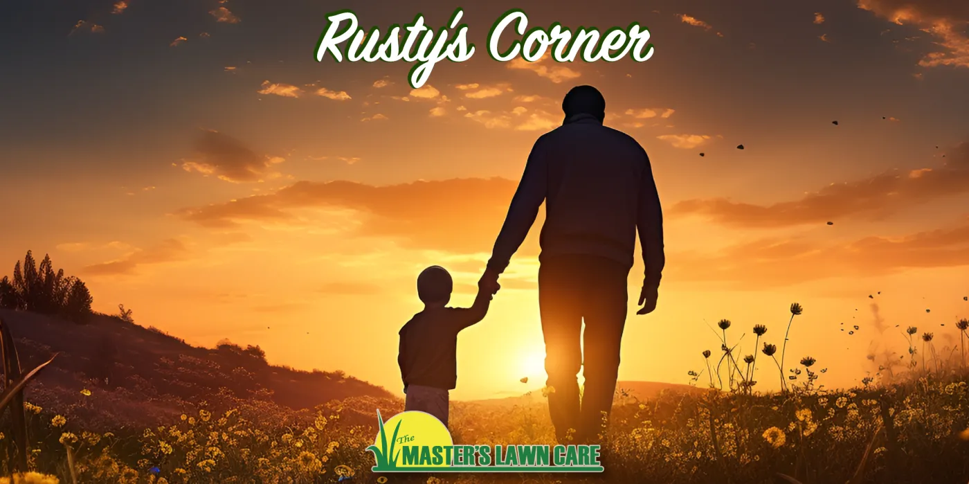 father and son holding hands walking into the sunset