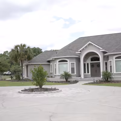 Wide front view showcasing the home's updated landscape beds, new plantings, and refreshed curb appeal.