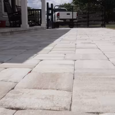 New paver walkway and patio area installed alongside the home, creating a clean transition to the outdoor space.