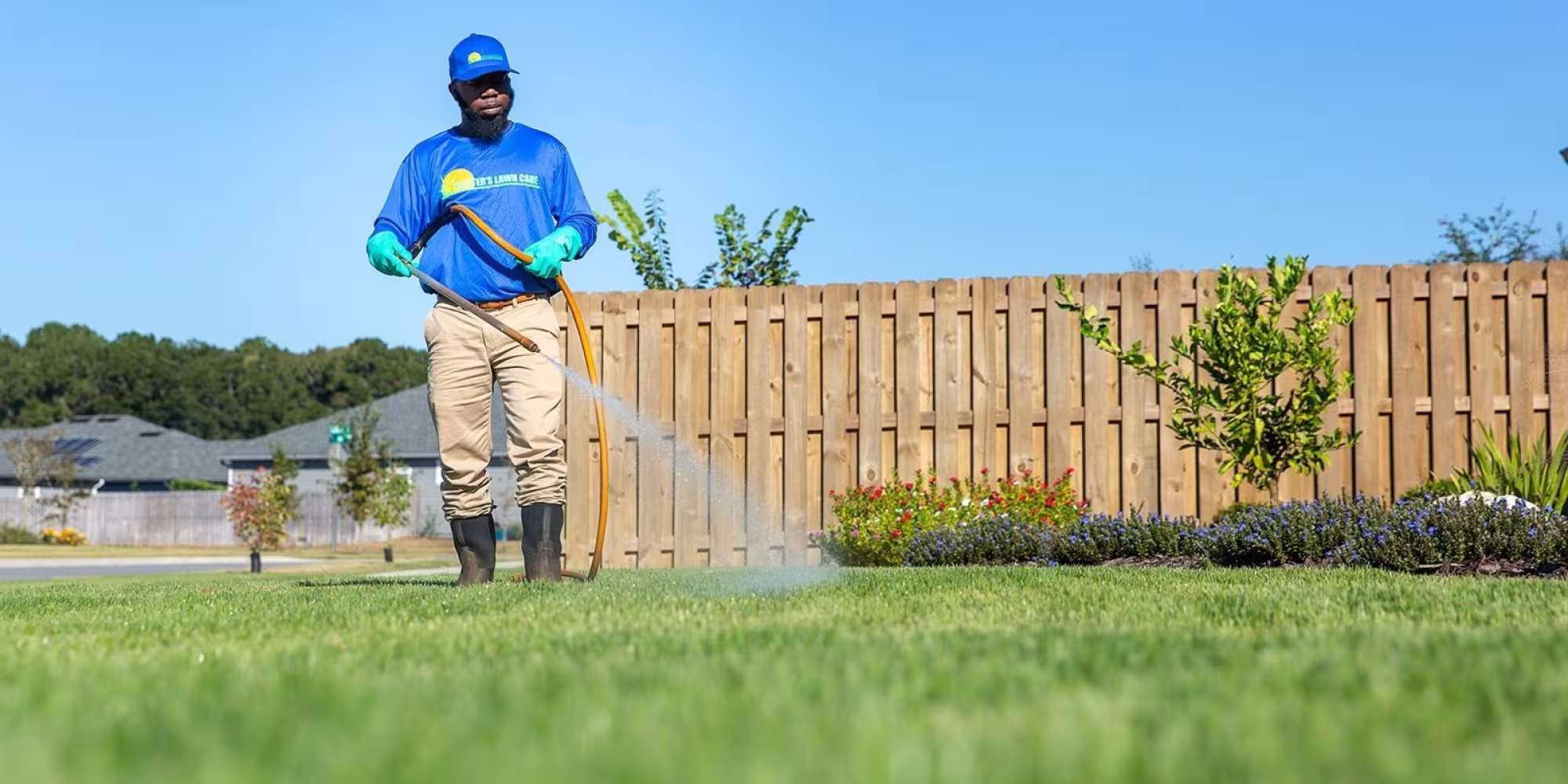 lawn tech spraying yard for pests