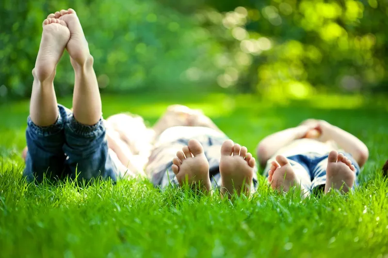kids laying in the grass